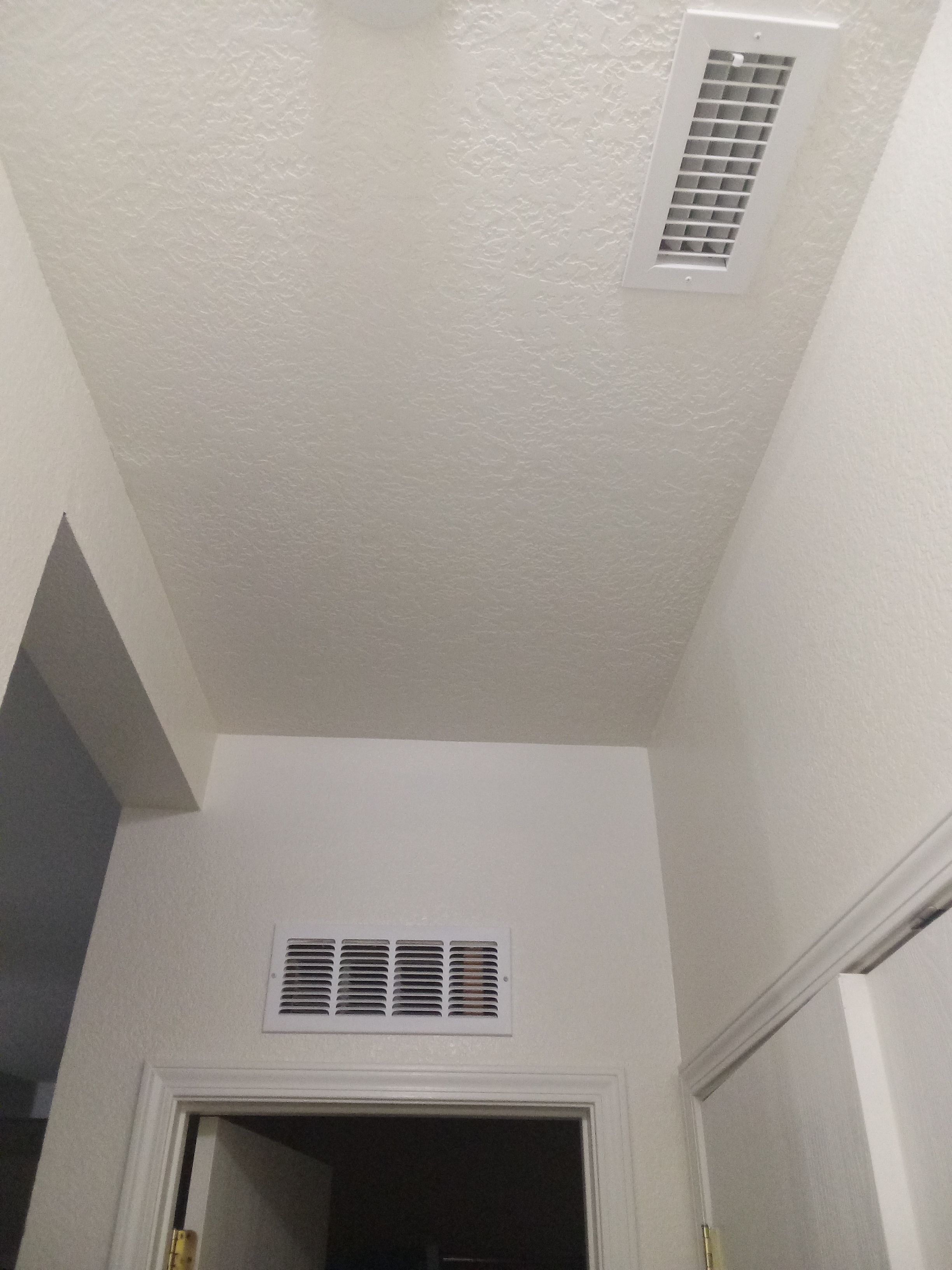 A bathroom with a ceiling fan and a door