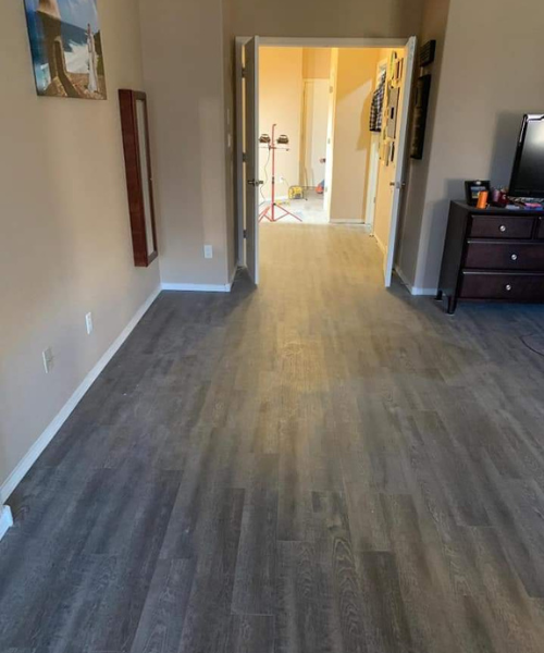 A living room with hard wood floors and a flat screen tv